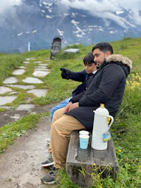 a man and a child sitting on a bench