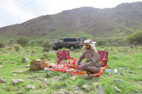 a man sitting on a blanket